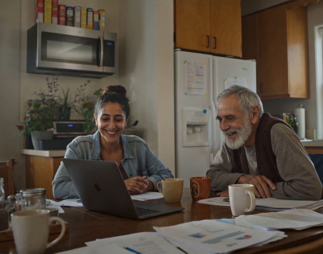 Two generations talking at a kitchen table